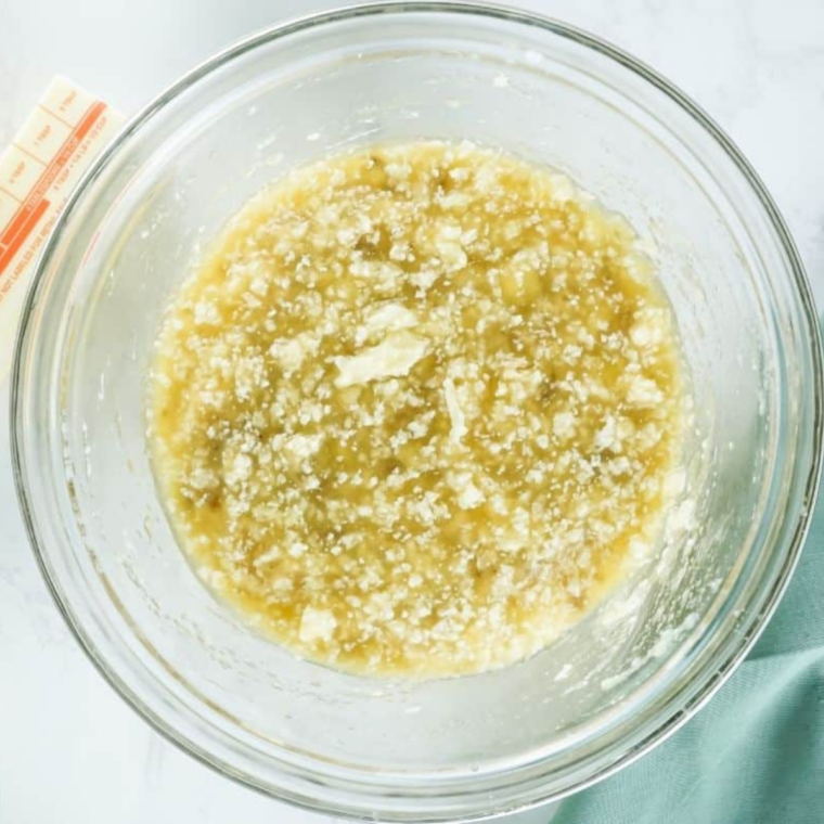 Vegan butter and sugar creamed together in a glass mixing bowl