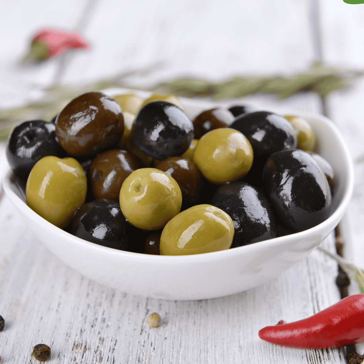 Golden, crispy air fryer marinated olives served in a small bowl, ready to enjoy as a snack or appetizer.