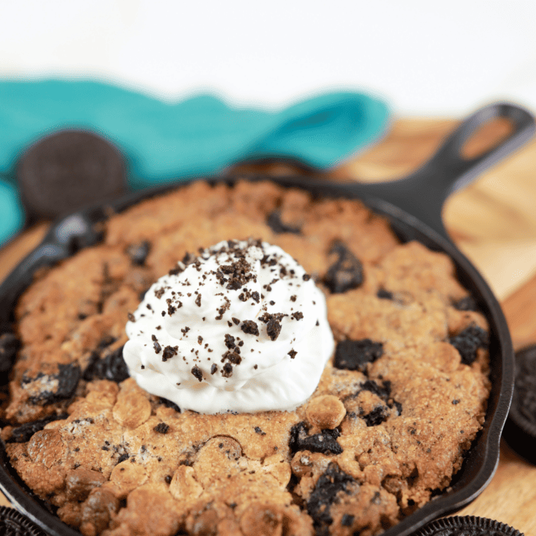 Cast-iron pan with cookie dough inside the air fryer, set to 340°F for baking.