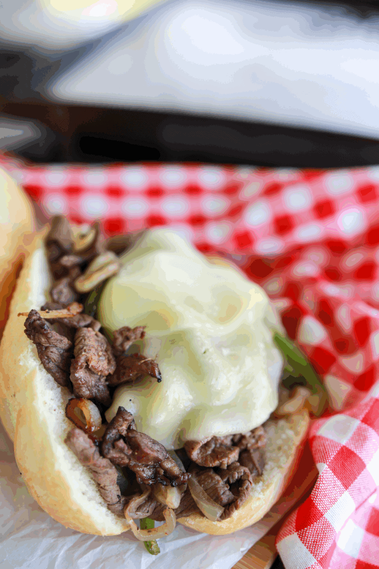 "Ninja Foodi Philly Cheesesteak with shaved beef, peppers, onions, and melted cheese"