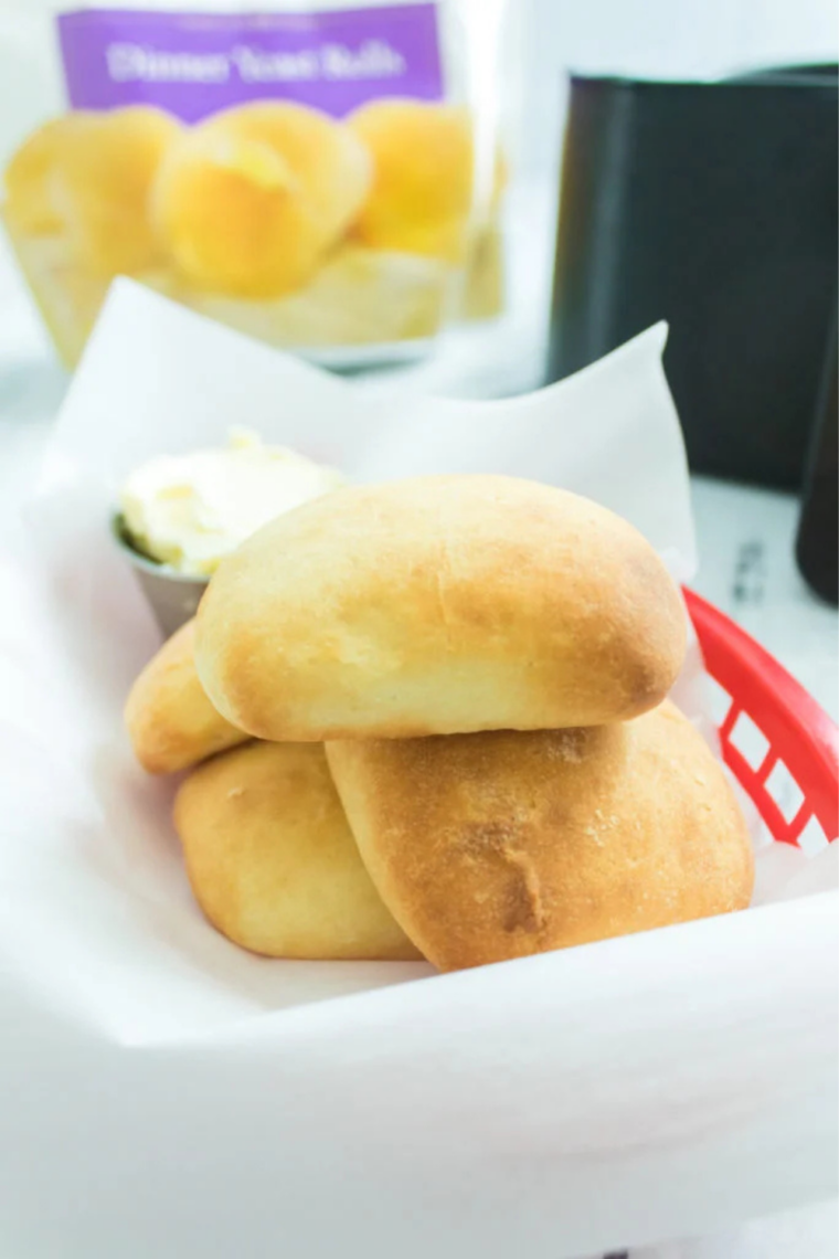 Plate of golden Sister Schubert's rolls fresh from the air fryer, brushed with butter