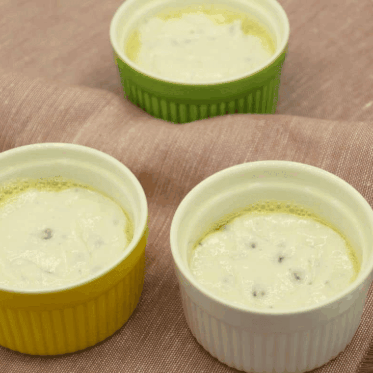 Filling greased muffin cups with banana nut muffin batter
