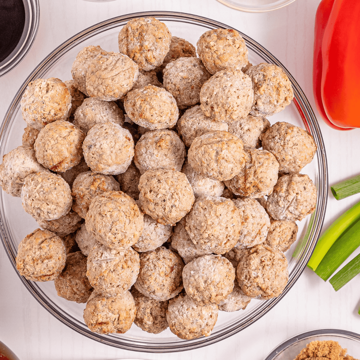Ingredients for air fryer meatball bubble up bake: meatballs, refrigerated buttermilk biscuits, marinara sauce, and shredded mozzarella cheese