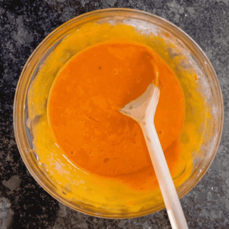 Creamy spiced pumpkin pie filling whisked smooth in a mixing bowl