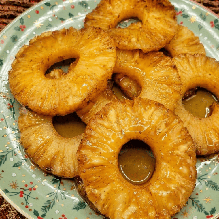 Air fryer pineapple rings coated in cinnamon and brown sugar, caramelized and golden brown