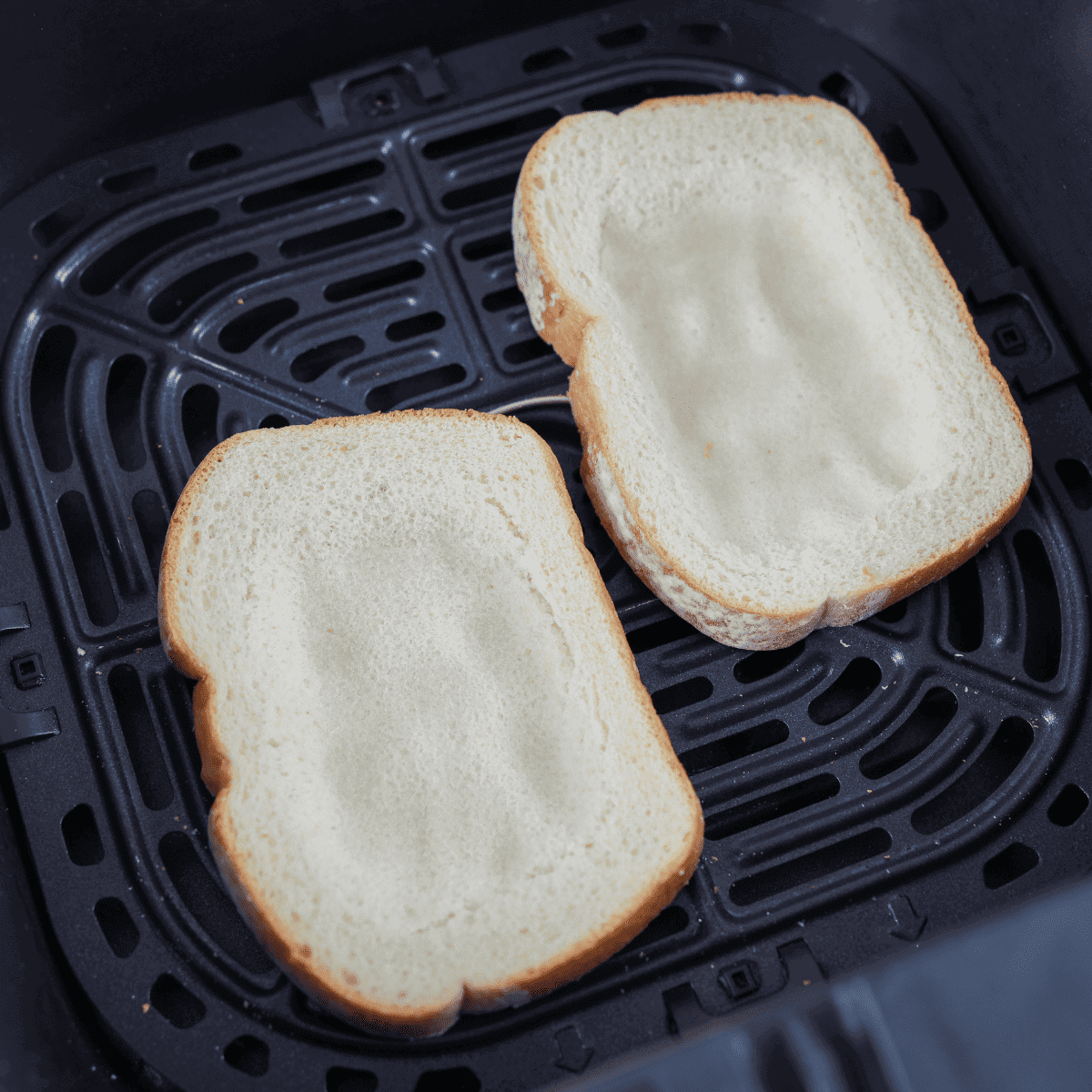 Bread slices placed in a preheated air fryer basket at 350°F, optionally brushed with butter.
