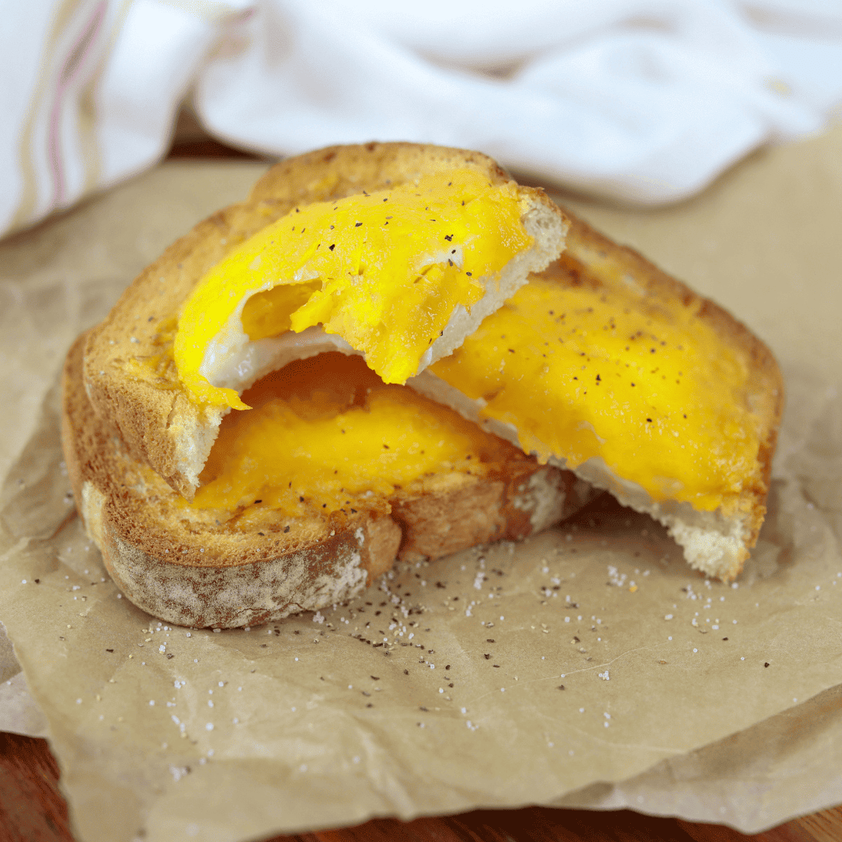 Easy Air Fryer Egg Toast with a golden, runny egg on crispy toasted bread, ready to serve.