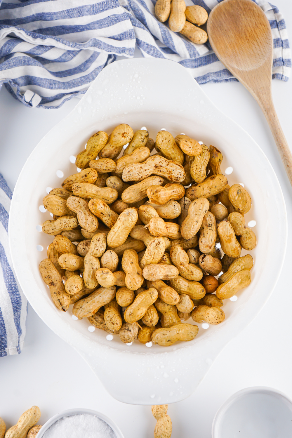 Raw peanuts soaking in a bowl of water with salt.