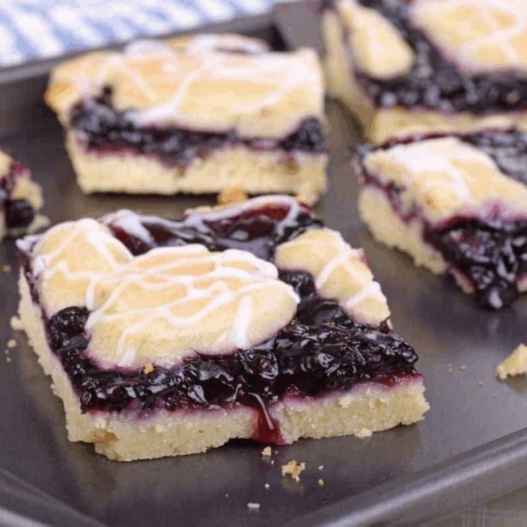 Blueberry pie bars cooked in the air fryer, sliced into squares with a golden crust and blueberry filling.