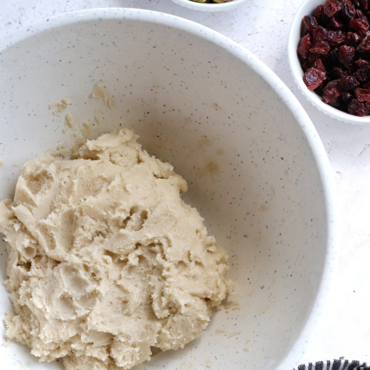 Green pistachio bread batter whisked in a large glass mixing bowl