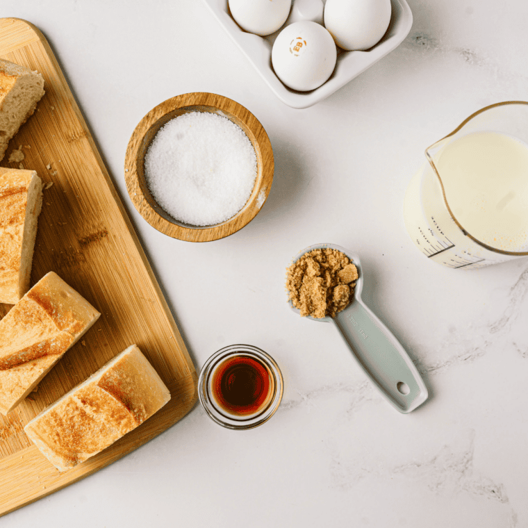 Ingredients for air fryer strawberry shortcake French toast including bread, cream cheese, eggs, and fresh strawberries