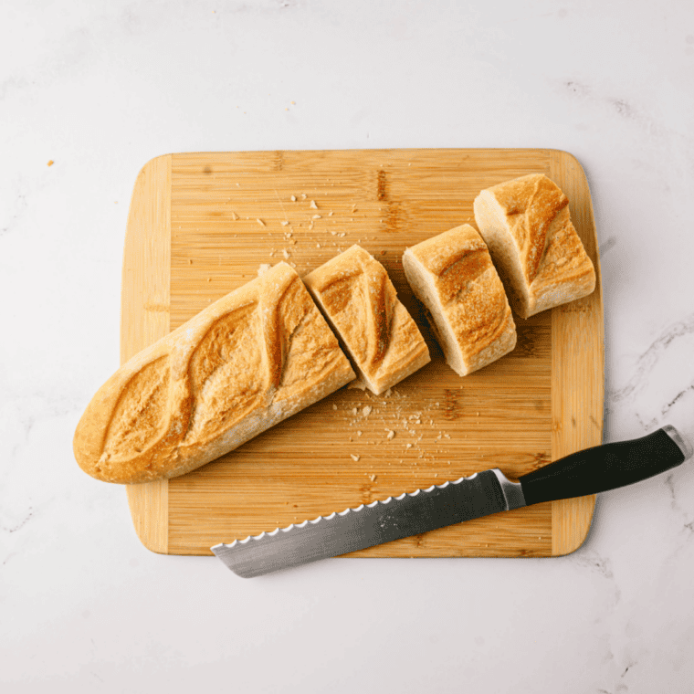 Slicing a loaf of brioche into thick slices for stuffed French toast
