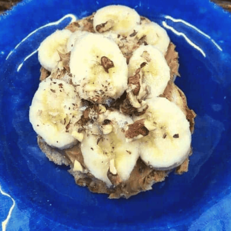 Toasted English muffins topped with mashed bananas and chopped nuts, fresh from the air fryer.