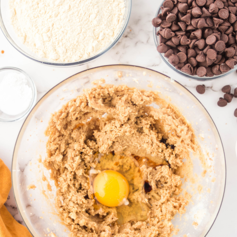 Adding an egg to the butter and sugar mixture for air fryer chocolate chip cookie pizza dough