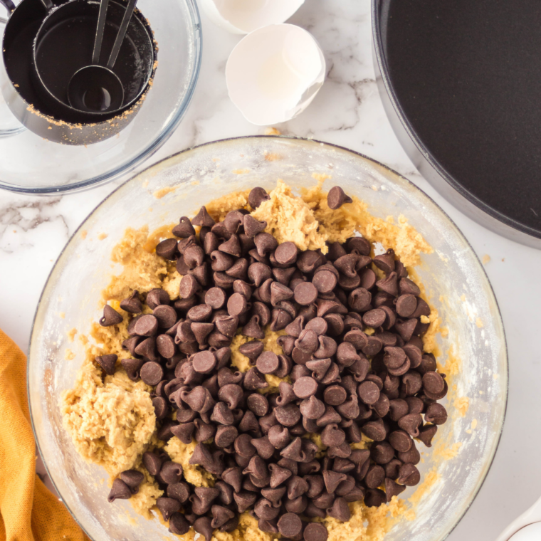 Chocolate chip cookie dough pressed into a round pan before air frying