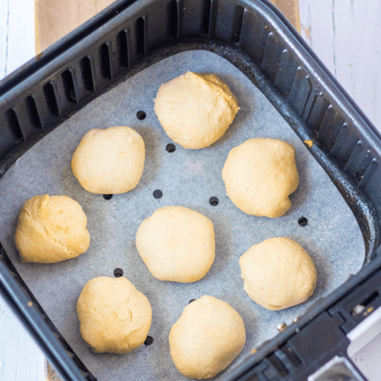 Air fryer basket set to 320°F cooking churro donut holes for 3–5 minutes.