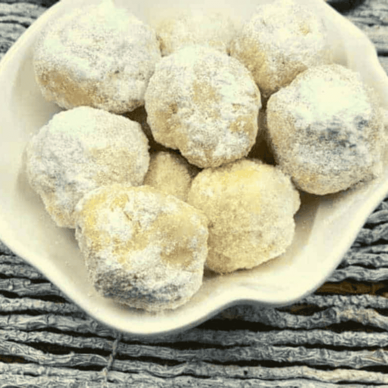 Air fryer churro donut holes coated in cinnamon sugar on a plate
