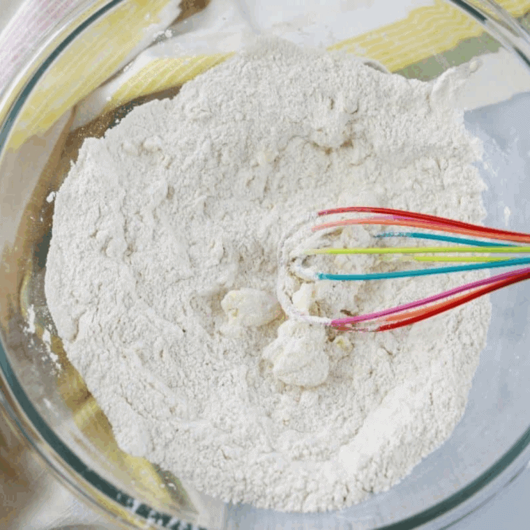 Mixing and creaming butter, sugar, flour, baking powder, salt, egg, and milk into smooth muffin batter