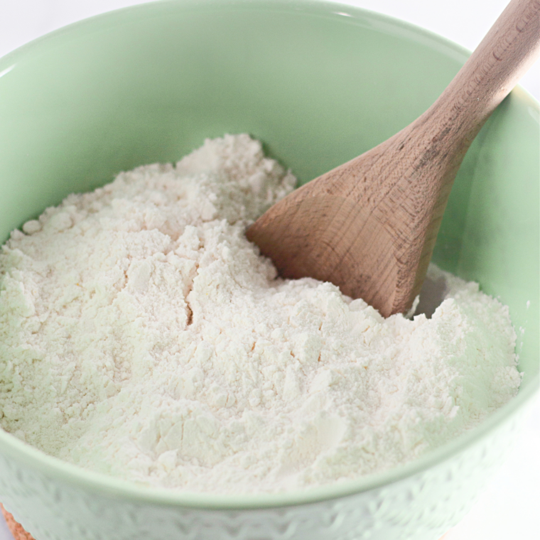 Mixing all-purpose flour, baking soda, baking powder, salt, Greek yogurt, vanilla, eggs, sugar, and butter in a large bowl