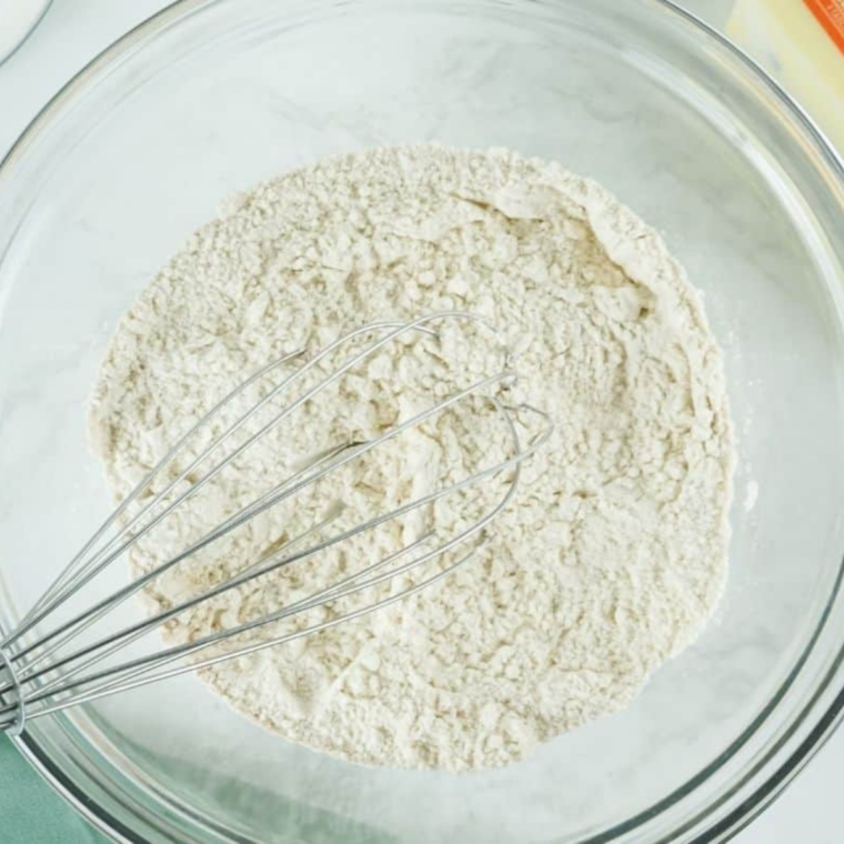 Flour, sugar, baking powder, baking soda, and salt whisked in a mixing bowl