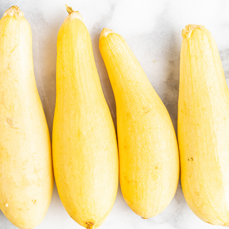 Sliced yellow summer squash, olive oil, garlic powder, and smoked paprika for an air fryer recipe