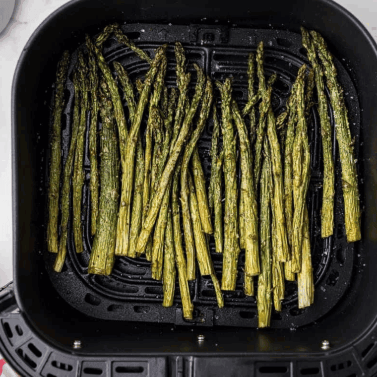 Cooked Chili’s Asparagus Recipe in the air fryer basket.