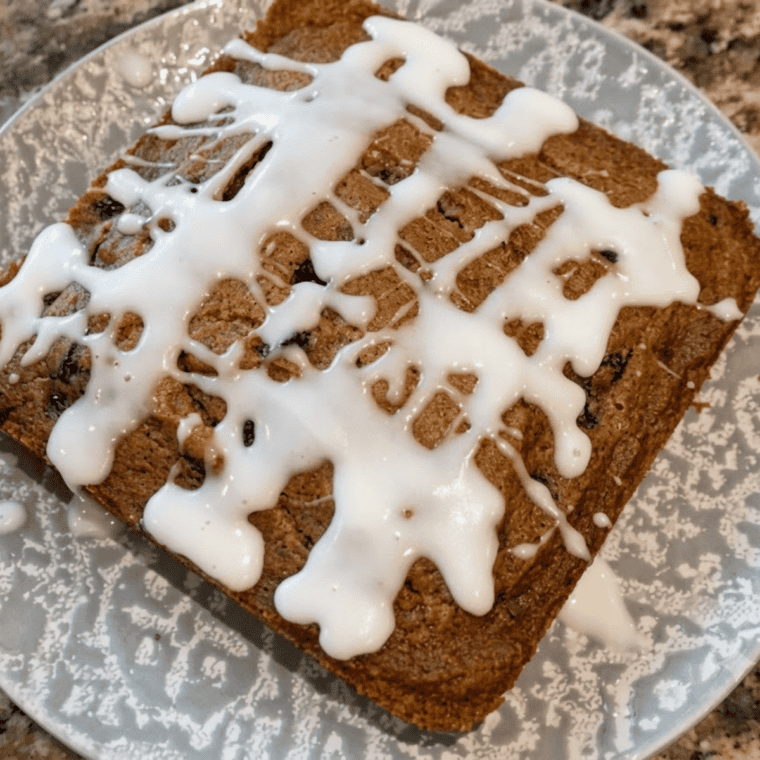 Sliced air fryer apple butter bars topped with powdered sugar icing