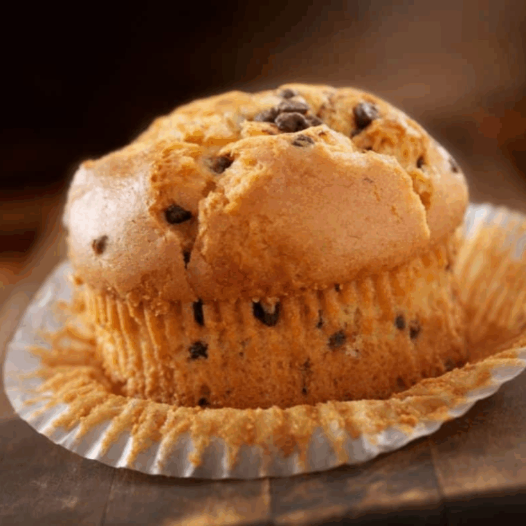 Golden, fluffy banana chocolate chip muffins baked in the air fryer with melted chocolate chips