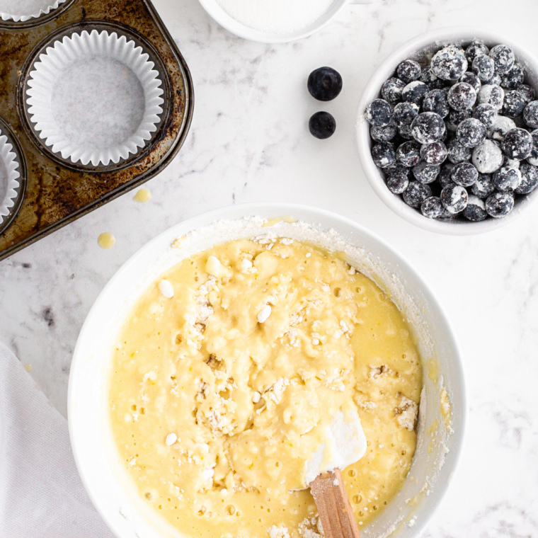 Eggs and vanilla beaten into creamed butter and sugar in a mixing bowl