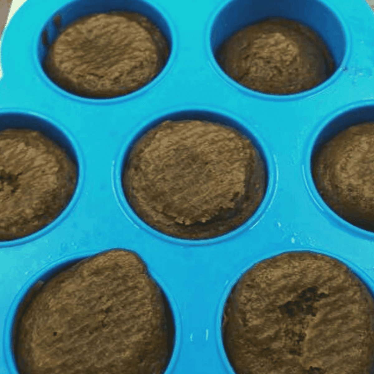 Air fryer brownie bites baking at 350°F in a silicone egg-bite mold
