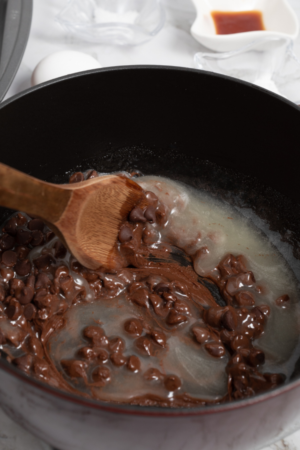 whisking sugars into brownie batter until glossy for crackly top texture