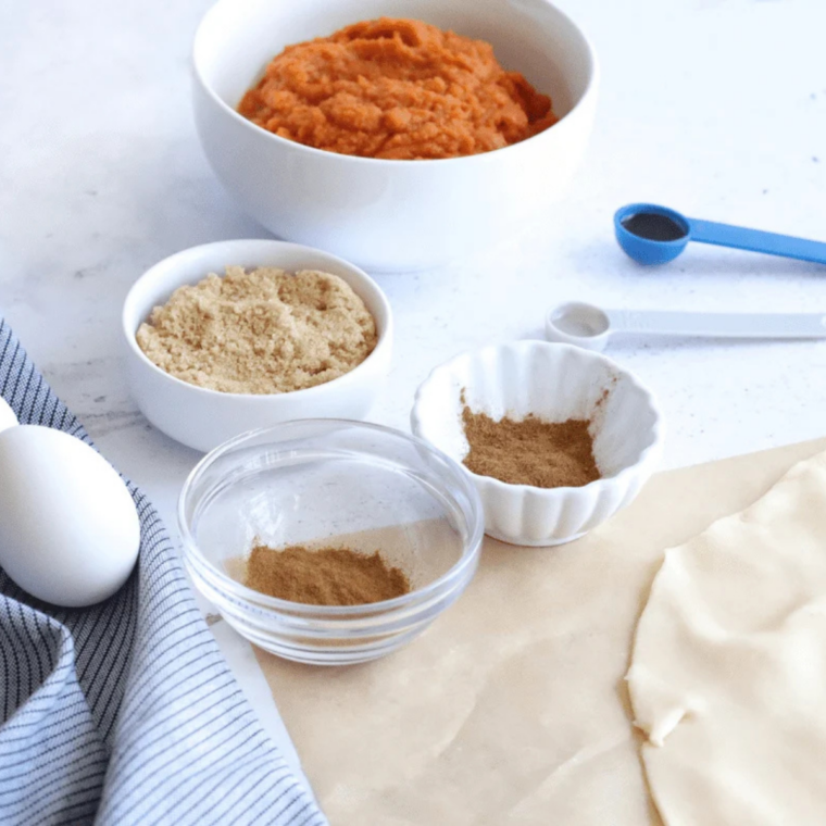 Ingredients for pumpkin nut bread: pumpkin purée, flour, sugar, eggs, oil, spices, and chopped pecans
