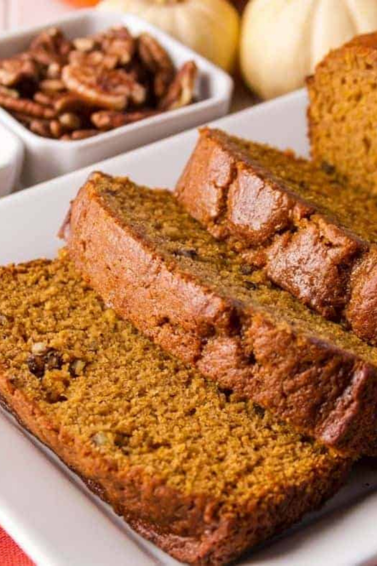 Sliced air fryer pumpkin nut bread showing a moist crumb studded with toasted pecans