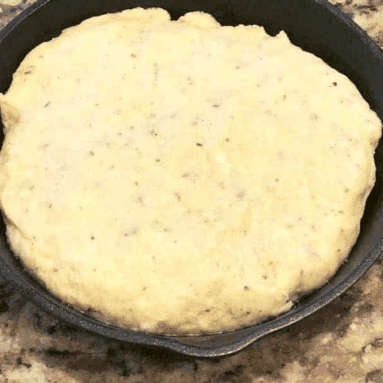 Kneaded bread dough shaped in greased pan, ready in air fryer at 350°F for 5–7 minutes