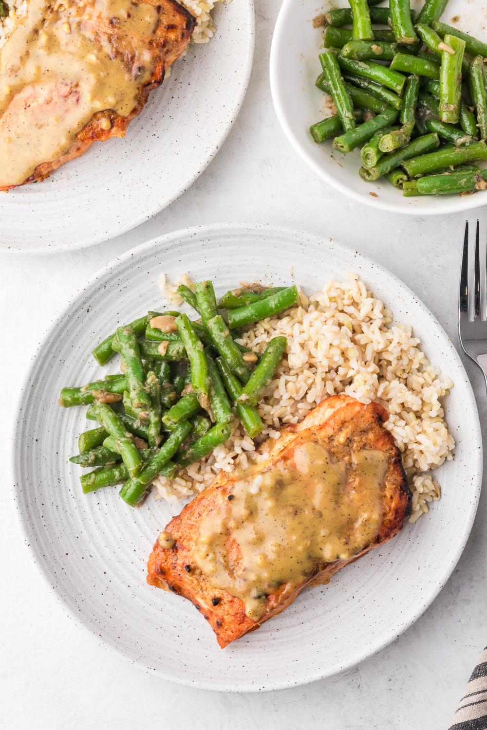 Cooking frozen salmon in the air fryer without thawing producing tender flaky salmon fillets with seasoned crispy exterior in just 16 minutes