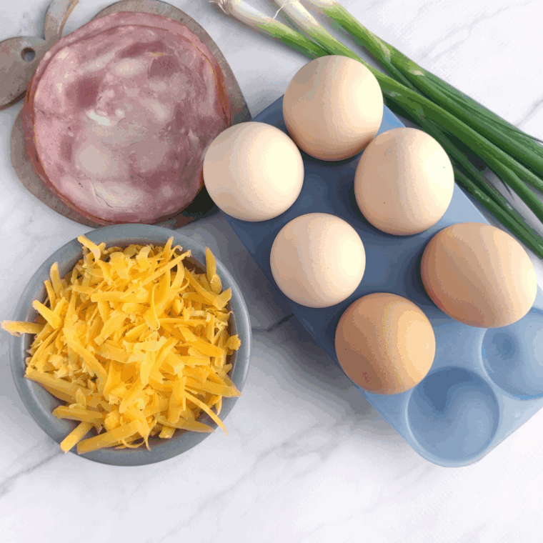 Ingredients needed for Super Easy Air Fryer Ham and Egg Cups on kitchen table.