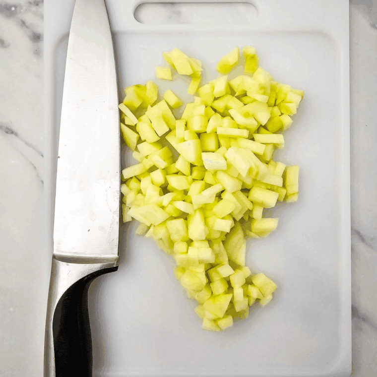 Preheat the air fryer to 320°F. Grease or line an 8x8-inch air fryer-safe pan with parchment paper and lightly coat with nonstick spray. Peel and chop the apple into small pieces.