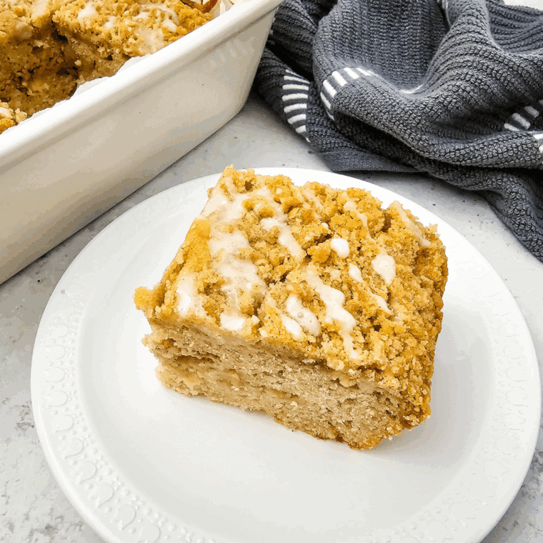 Golden Air Fryer Apple Coffee Cake topped with cinnamon sugar and fresh apple slices.