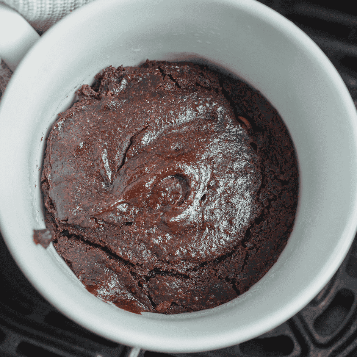 Fudgy air fryer brownie in a mug served warm with gooey chocolate center, quick single-serve dessert made in ceramic mug for easy treat
