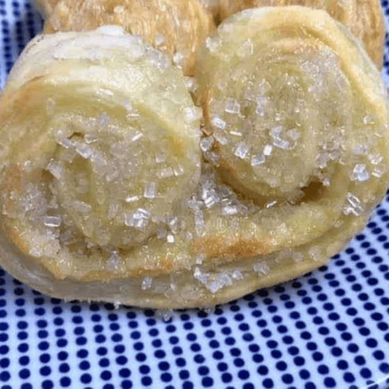 Golden, crisp Air Fryer French Palmier cookies with delicate layers on a plate.