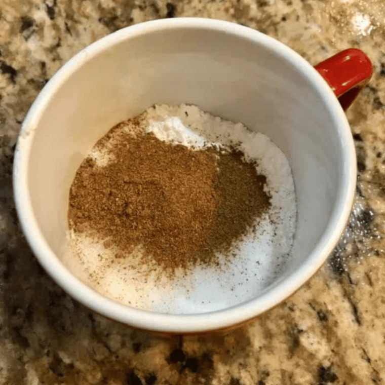 Ingredients for air fryer pumpkin mug cake including flour, sugar, pumpkin puree, milk, vanilla, and pumpkin pie spice