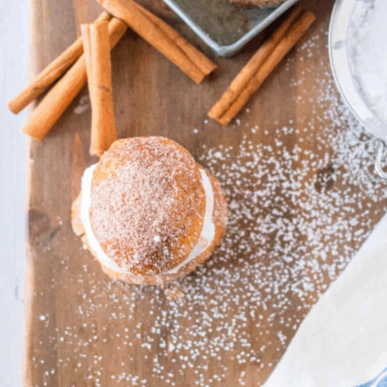 Golden pumpkin spice donut holes made in the air fryer, dusted with cinnamon sugar.