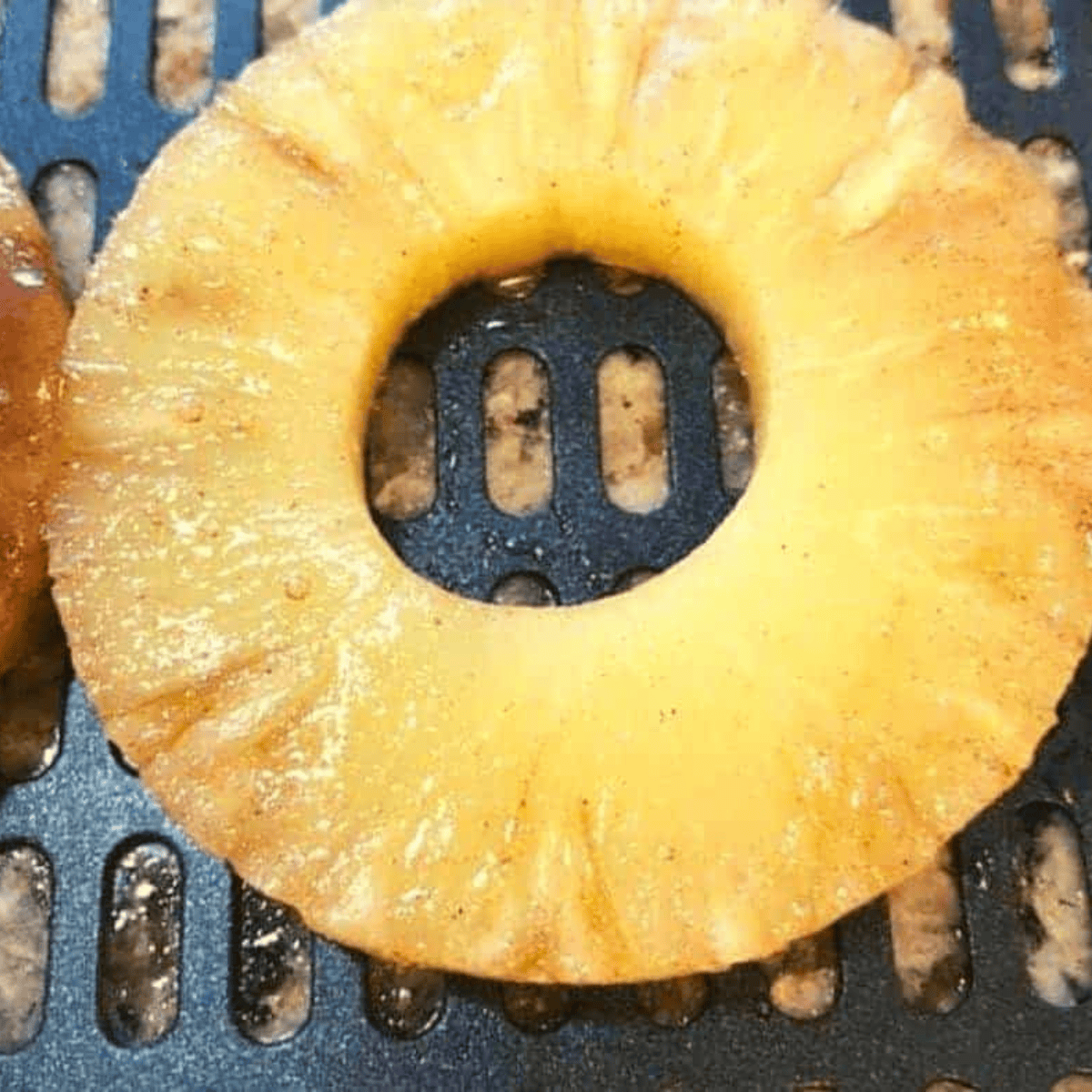 Pineapple rings in air fryer basket ready to cook at 350°F.