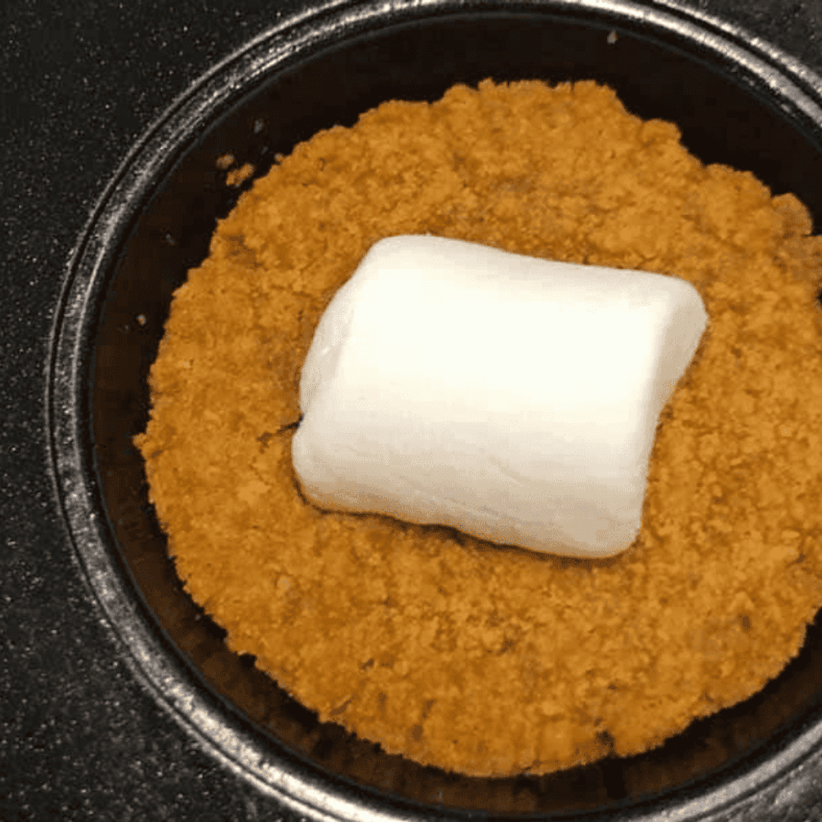 Marshmallows cut in half and pressed into cookie cups, browning in the air fryer.