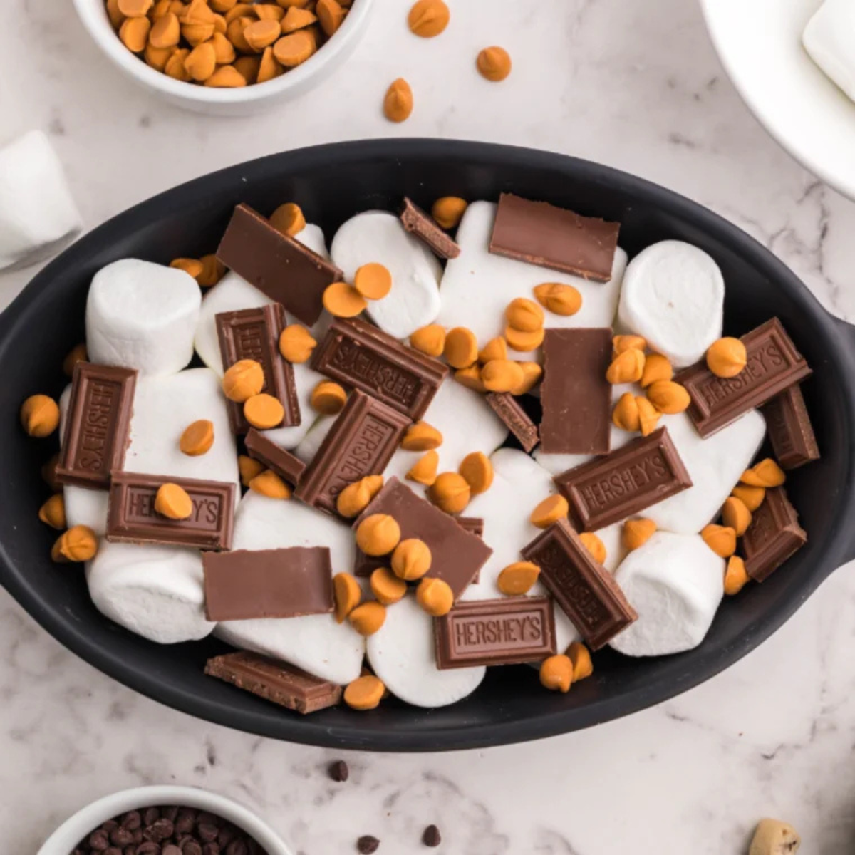 air fryer s'mores dip assembled in a cast iron skillet before cooking