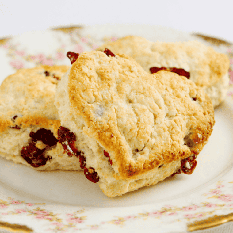Cherry scone broken open to show soft interior and dried cherry pieces