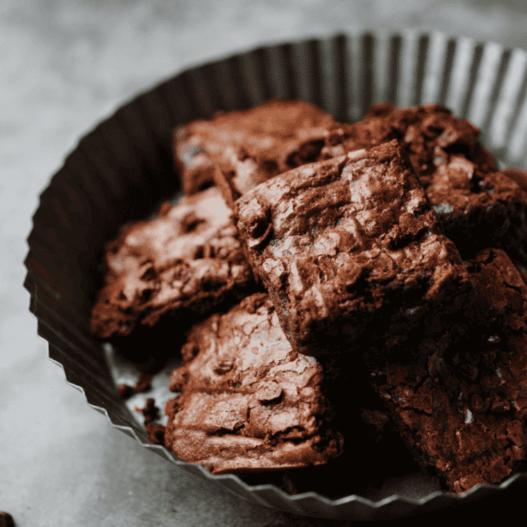 Small batch air fryer brownies cut into fudgy squares with crackly tops on a cooling rack.