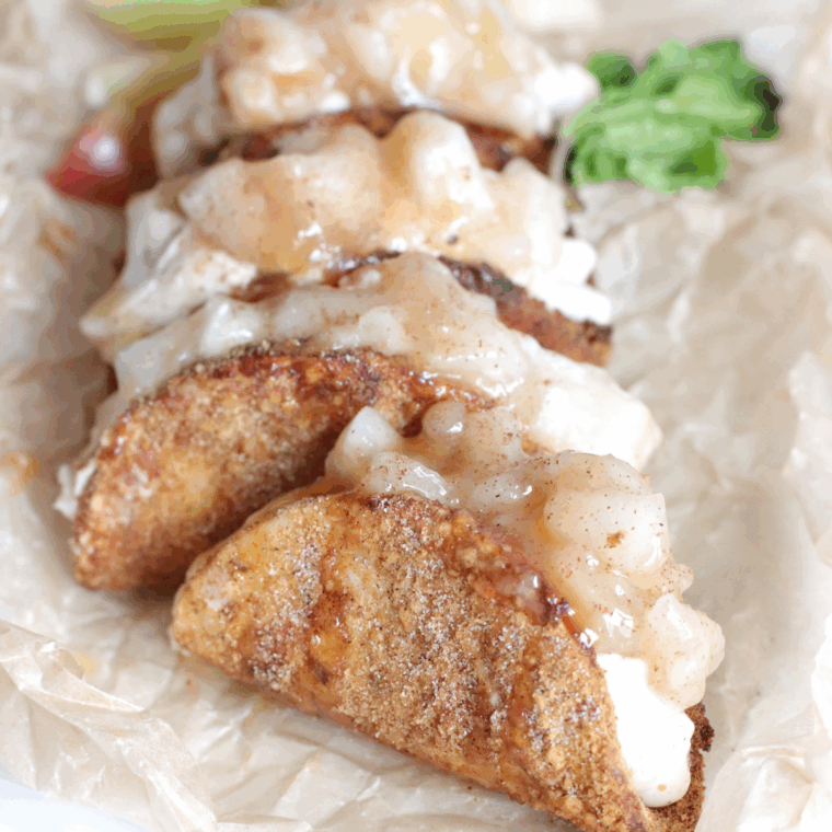 Crispy dessert tacos filled with apple pie filling and creamy cheesecake, fresh from the air fryer.