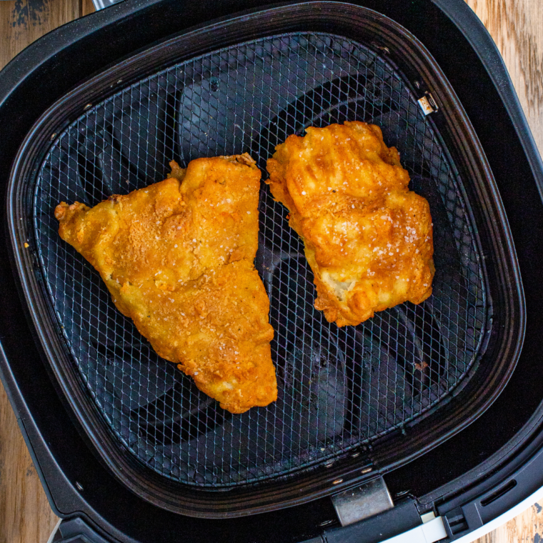 Crispy golden air fryer beer battered fish in the air fryer basket