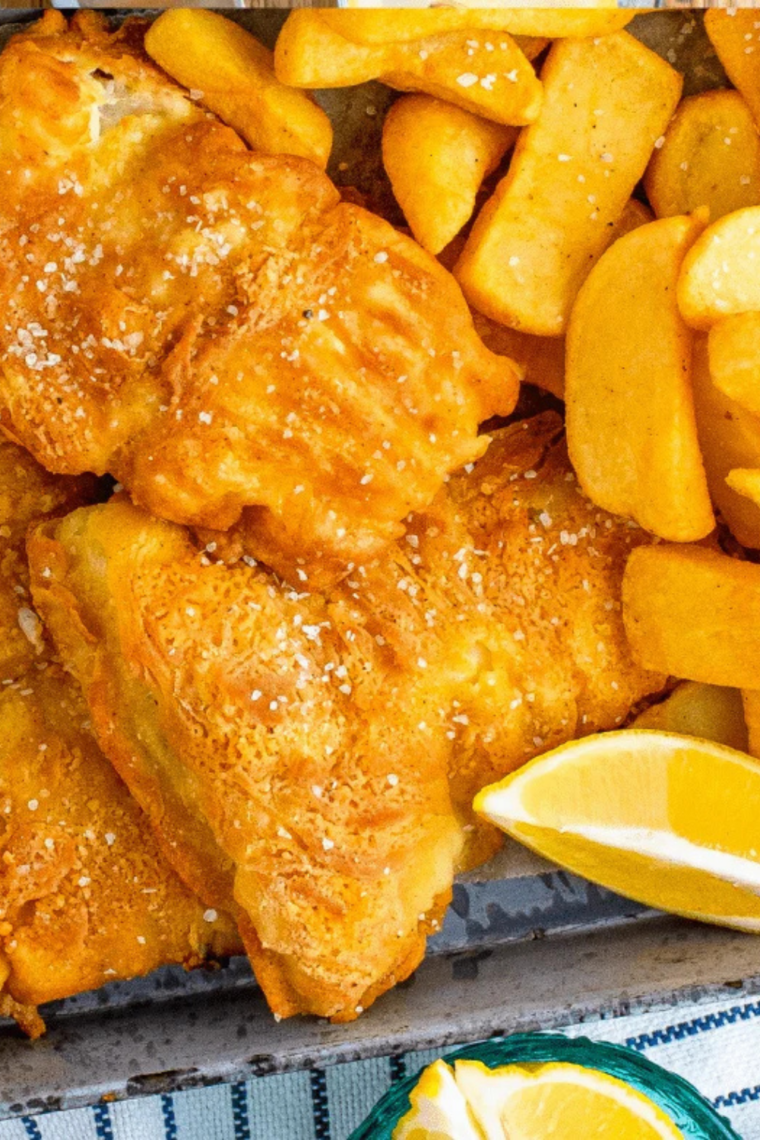 Air fryer beer battered fish, golden and crispy, served with lemon wedges and tartar sauce